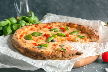 Board with delicious pizza Margherita on table