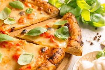 Board with delicious pizza Margherita on table, closeup
