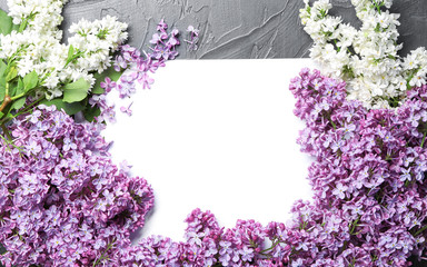 Frame made of blossoming lilac on grey background