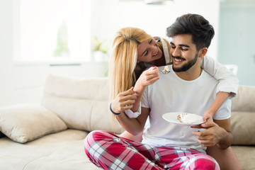 Cute young cheerful couple spending time at home