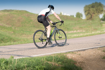 Fototapeta na wymiar triathlete cycling on a bicycle at the training road in Moscow
