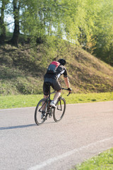 Fototapeta premium triathlete cycling on a bicycle at the training road in Moscow