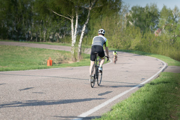 triathlete cycling on a bicycle at the training road in Moscow
