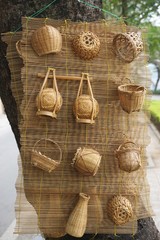 Miniature baskets hanging on a bamboo mat
