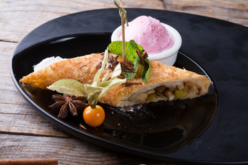 Apple strudel served with ice cream