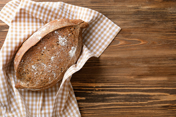 Fresh tasty bread on wooden background
