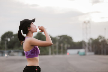Fitness woman drinking water. Fitness and healthy lifestyle concept.