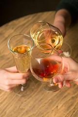 Hands holding wine glasses