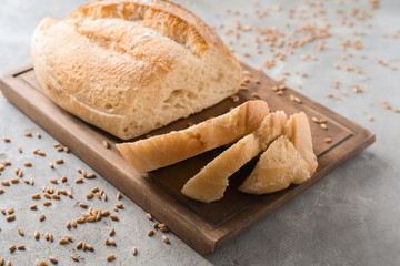 Fresh tasty bread on grey background