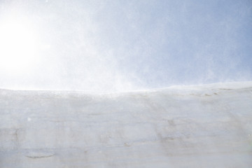 Tateyama Kurobe Alpine Route, wind blowing snow fall from the wall in Toyama Prefecture, Japan.