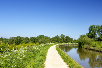 Fototapeta na wymiar Trent and Mersey canal with towpath in Cheshire England United Kingdom