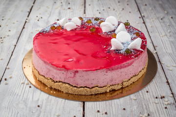 Strawberry Cake dessert with candies on wooden background