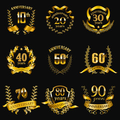 Set of gold anniversary badges with laurel wreaths, shield, numbers. Decorative emblem of jubilee on gray background. Filigree element, frame, border, icon, logo for web, page design in vintage style