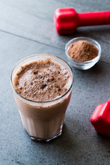Chocolate Protein Shake Smoothie with Whey Protein Powder and Red Dumbbells