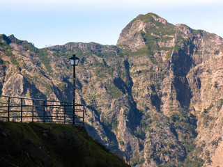 Fototapeta na wymiar Lamppost and railings in a mountainous landscape