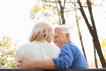 Mature couple resting in park on spring day