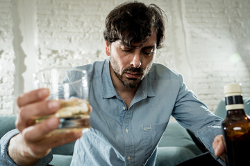 latin businessman drunk and depressed at home in alcoholic concept