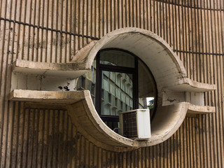 Round window with air conditioning unit in Skopje, Republic of Macedonia - obrazy, fototapety, plakaty