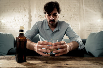 latin businessman drunk and depressed at home in alcoholic concept