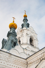 Fototapeta premium Golden cupolas, walls and towersof old ancient cathedral on the sky background