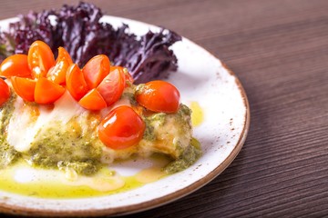 Juicy chicken breast and cherry tomatoes with  pesto sauce.