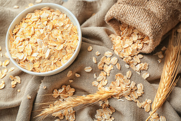 Bowl with oatmeal flakes on table