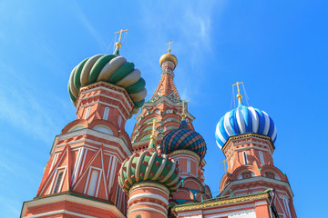 Fototapeta na wymiar Domes of St. Basil's Cathedral on Red square on a blue sky background