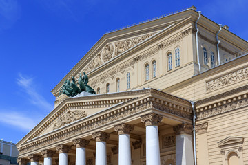 Facade of Bolshoi Theatre closeup on a blue sky background on a sunny summer morning