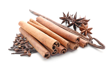 Cinnamon sticks and spices on white background