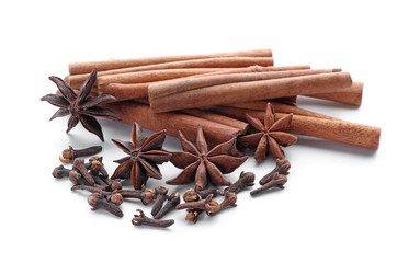 Cinnamon sticks and spices on white background