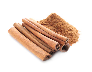 Aromatic cinnamon sticks and powder on white background