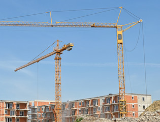Tower cranes works at the construction site