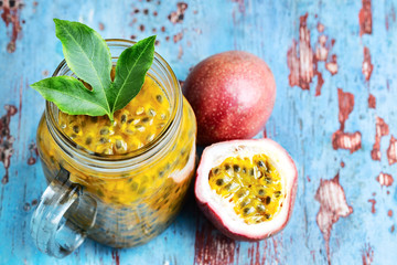 Passion fruit in a glass jar on blue wooden table