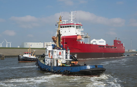 Freightship with towboat. Netherlands. Harbor. Coaster