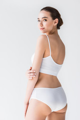Fototapeta premium attractive caucasian woman in white lingerie looking at camera isolated on gray background
