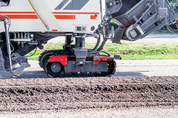 Unit removes the asphalt on the road