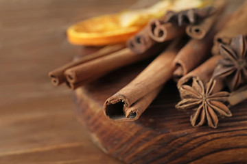 Aromatic cinnamon sticks on board, closeup