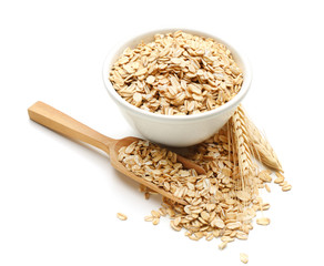 Bowl with raw oatmeal on white background