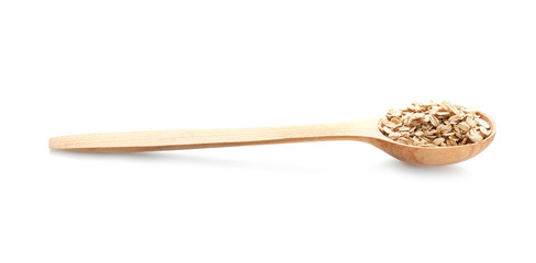 Spoon with raw oatmeal on white background