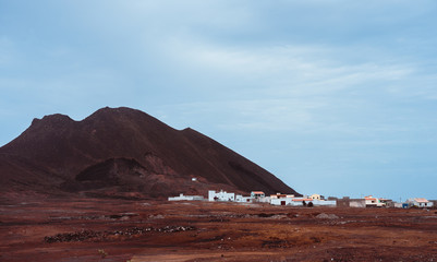 Local village Calhau at the foot of the volcanic crater. Single martian like dry red rock stand out...