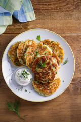 Mashed potato and cheese cakes, served with sour cream or yogurt. Potato Pancakes, Fritters. overhead, vertical