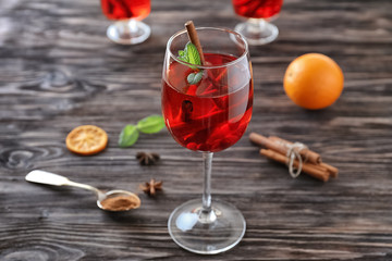 Glass with sangria drink on table