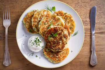 Mashed potato and cheese cakes, served with sour cream or yogurt. Potato Pancakes, Fritters. overhead, horizontal