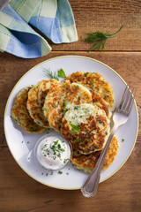 Mashed potato and cheese cakes, served with sour cream or yogurt. Potato Pancakes, Fritters. overhead, vertical