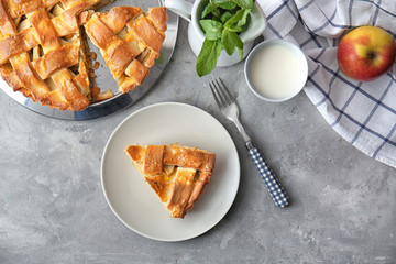 Composition with delicious apple pie on grey background, top view