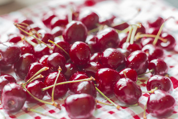fresh, ripe, juicy cherries lying on the table, selective focus, shallow depth of field