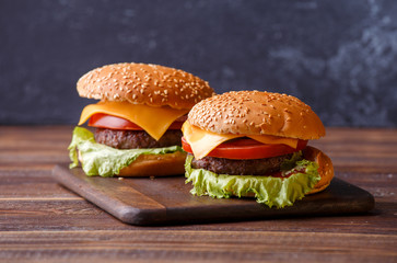 Photo of two hamburgers on a wooden table