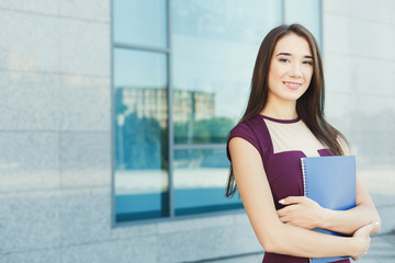Portrait of a confident young businesswoman with notepad