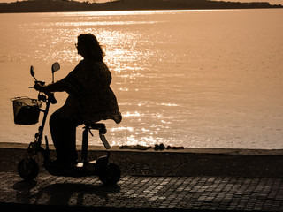mature woman in electric mini scooter © stefano