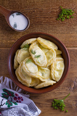 Dumplings, filled with cottage cheese (farmer cheese). Varenyky, vareniki, pierogi, pyrohy. View from above, top studio shot